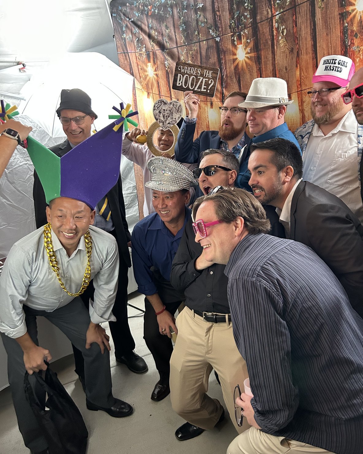 Two guests posing playfully in police hats at wedding photo booth